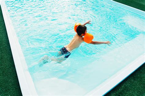 Young Boy In Pool With Floaties Stock Image Image Of Treading Swims