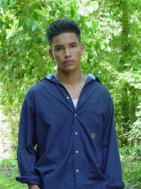 sexy latino twink posing for the camera outdoors
