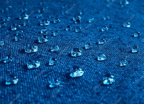 Premium Photo Rain Water Droplets On Blue Waterproof Fabric