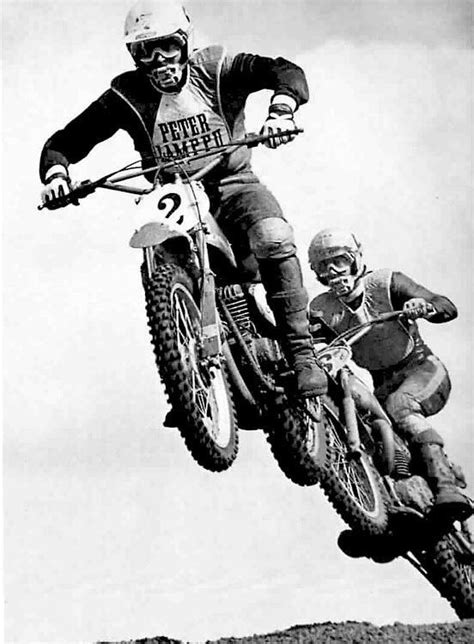 A Man Flying Through The Air On Top Of A Dirt Bike While Riding Down A Hill