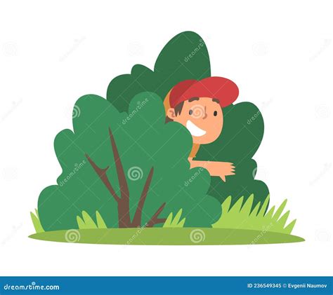 Little Boy In Cap Playing Hide And Seek Concealing Behind Green Bush