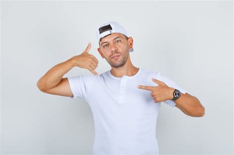 Free Photo Young Male In White T Shirt Cap Doing Call Me Gesture