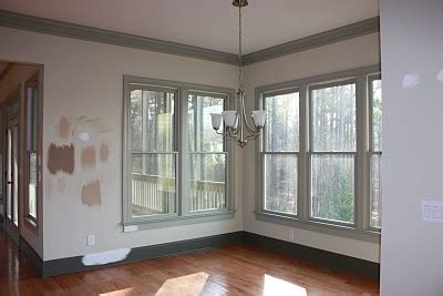 A deeper yellow sets off this beautiful front door and lowers the walls in this foyer. lighter walls, darker trim. | For the Home | Pinterest