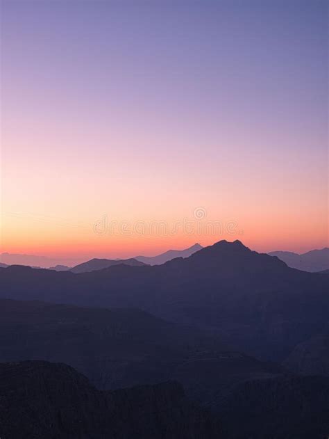 Aesthetic Vertical View Of The Rocky Hills At A Soft Sunset Stock Photo