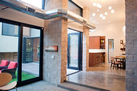 Dark grey weathered wooden floors work perfect for a rustic bathroom. Denver custom home showing exposed duct work, interior masonry, and exposed concrete floors ...