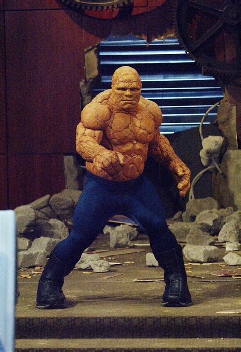 A Man Dressed As The Thing Standing On Some Steps