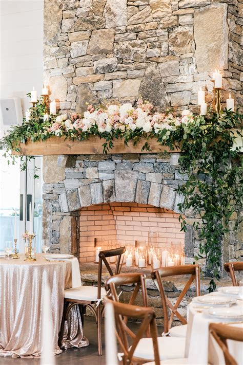 the fireplace is decorated with flowers and candles for an elegant