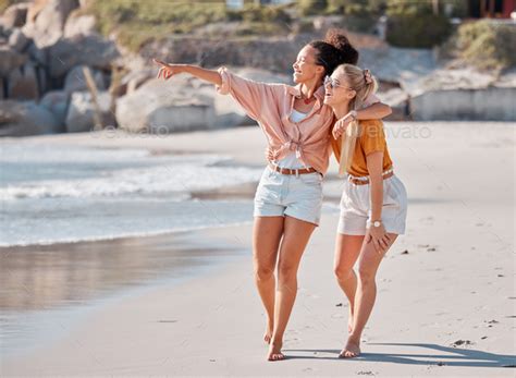 couple hug on beach lesbian and happy with ocean gay women outdoor with adventure and freedom