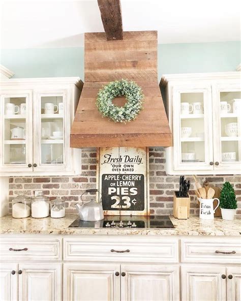 The kitchen is immaculate with distressed cabinets, a dark colored countertop island, statuesque. Pin by Kathleen Volling on house | Rustic kitchen cabinets ...