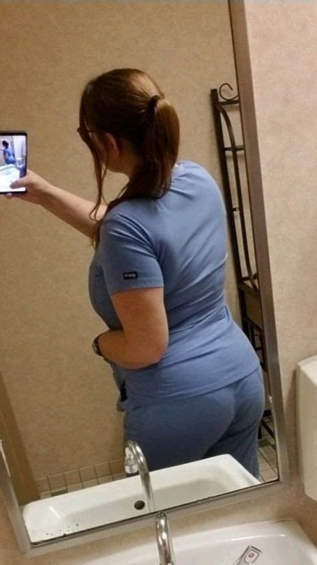 A Pregnant Woman Taking A Selfie In Front Of A Mirror With Her Cell Phone