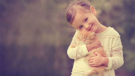 Smiley Cute Little Girl With Brown Cat Kitten Wearing