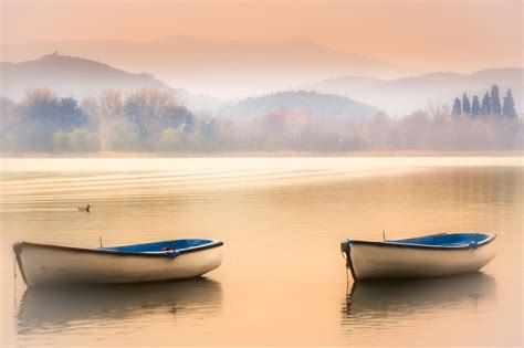 Two White Canoes Near Mountain At Daytime Banyoles Hd Wallpaper