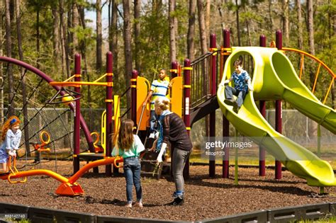 Multiethnic Elementary School Children Playing On Playground At Park