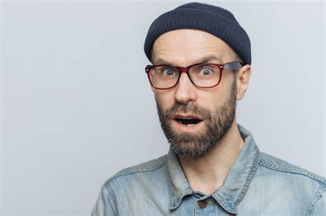 Premium Photo Surprised Terrified Unshaven Male Keeps Mouth Widely