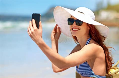 Taking A Selfie On The Beach Shot Of A Beautiful Young Woman Taking A