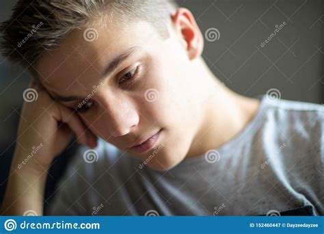 Close Up Of Unhappy And Depressed Teenage Boy At Home Stock Image