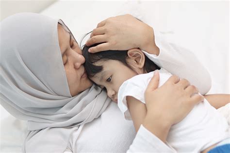 Asian Muslim Mother Hijab Calming Her Sad And Crying Daughter Single