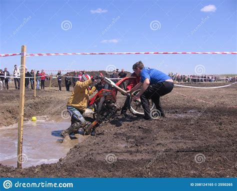 Biker Overcomes An Obstacle On The Motocross Track Editorial Image