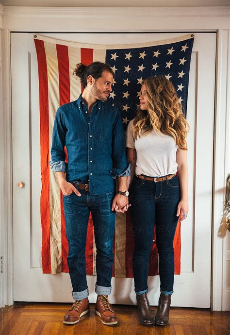 hipster couple standing in front of american flag by stocksy contributor trinette reed stocksy