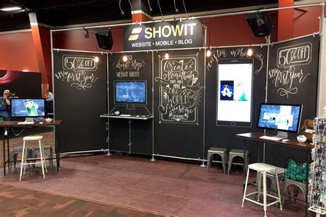 An Exhibit Booth With Chalkboard Walls And Tables