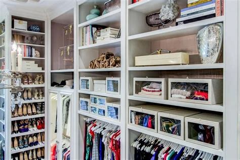Walk In Closet Boasts Built In Clothes Rails With Overhead Shelves