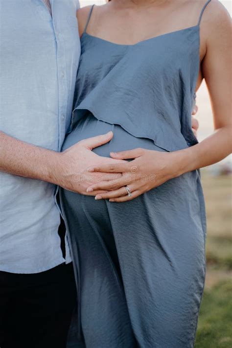 Vertical Closeup Shot Of A Husband And Pregnant Wife Posing Together At A Maternity Shoot Stock