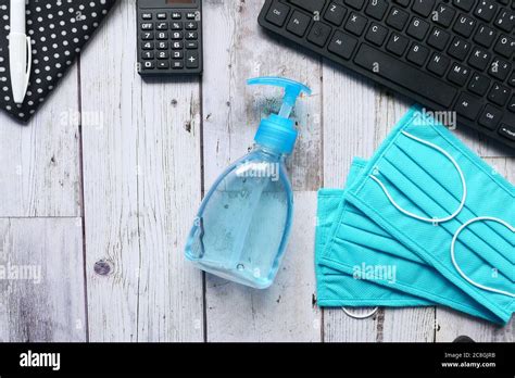Surgical Masks And Hand Sanitizer On Office Desk Stock Photo Alamy