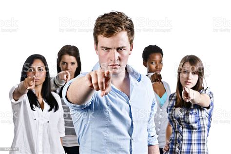 Five Angry Young Adults Point At The Camera Accusingly Stock Photo