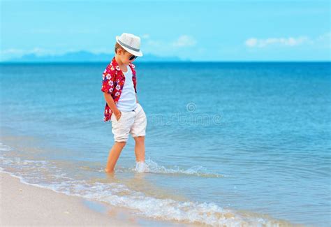 Fashionable Boy Kid Playing In Waves On Summer Beach Stock Image