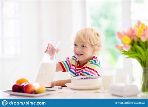 Child Eating Breakfast Kid With Milk And Cereal Stock