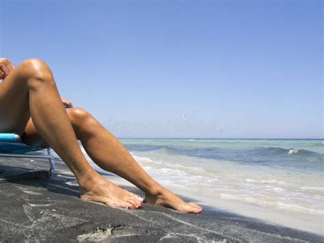Attractive Female Legs Relaxing On A Beautiful Beach Stock Photo