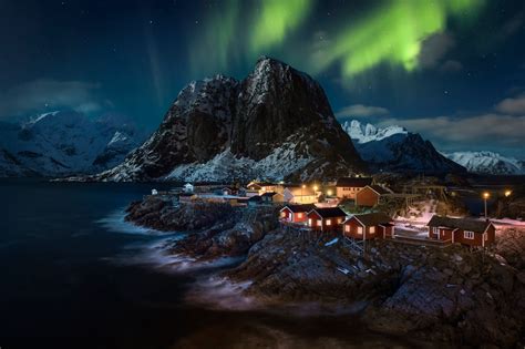 Northern Lights Over Village In Lofoten Norway By Raúl Podadera Sanz