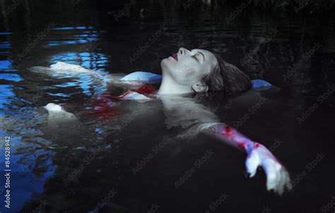 Beautiful Drowned Woman In Bloody Dress Lying In The Water Stock Photo