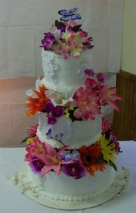 Wild Flower Wedding Cake Silk Flowers With Cherubs On A Buttercream Wedding Cake Wedding Cakes