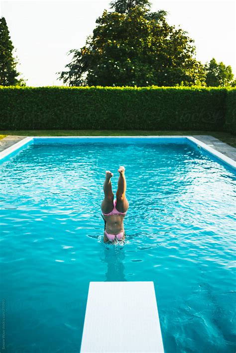 Woman Diving Into Swimming Pool Del Colaborador De Stocksy Simone