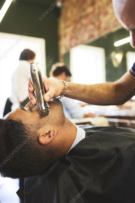 Male Barber Shaving Face Of Customer In Barbershop Stock Image F027
