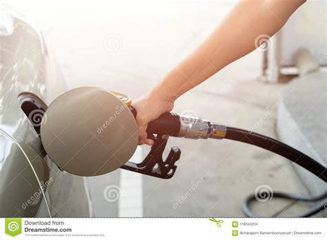 Closeup Of Man Pumping Gasoline Fuel In Car At Gas Station Fuel Stock