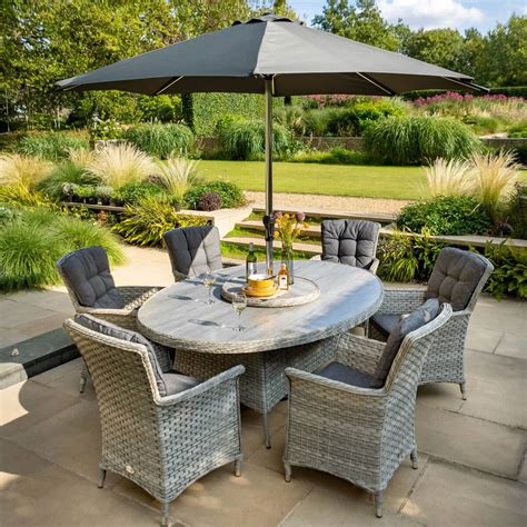 There was a big table ___ the middle of the room. Hartman Heritage Tuscan 6 Seat Elliptical Dining Set with ...