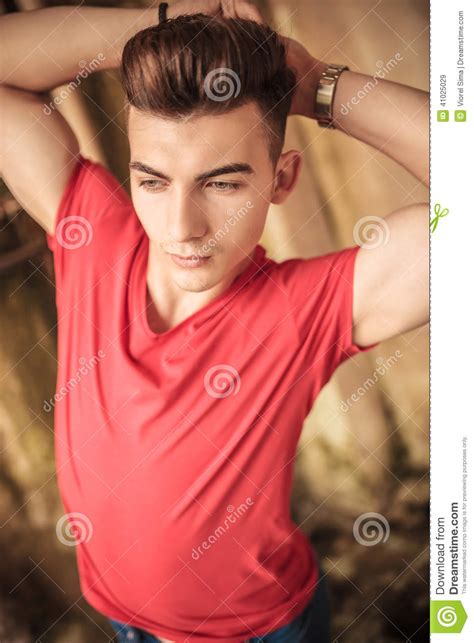 Man Flexing His Biceps Muscles And Looks Away Stock Image