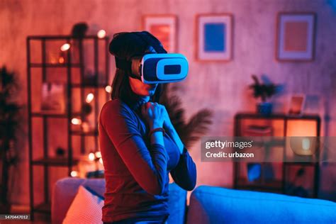 Young Woman Playing A Scary Game On A Virtual Reality Headset At Home