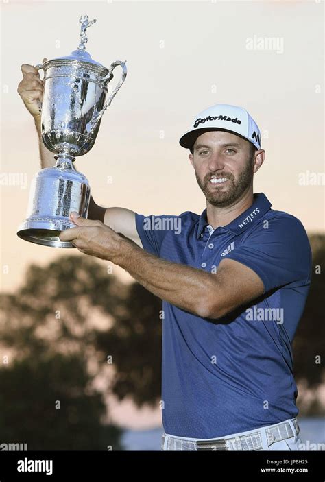 Dustin Johnson Of The United States Poses With The Trophy After Winning