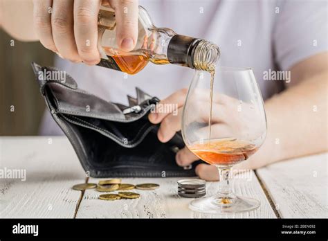 Empty Bottle On The Background Of Money Alcoholism And Poverty Stock