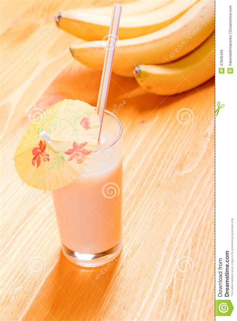 Banana Juice In A Glass On The Table Yellow Bananas On Background Stock