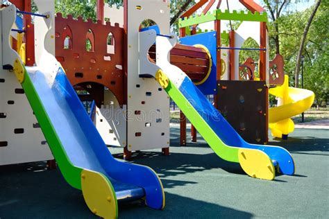 Children Playground With Colorful Slides In The Park Stock Photo