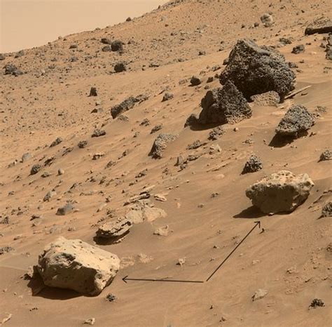 An Image Of Rocks And Sand On The Side Of A Hill With A Arrow Pointing