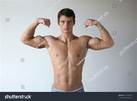 Young Muscular Man Flexing His Biceps Stock Photo