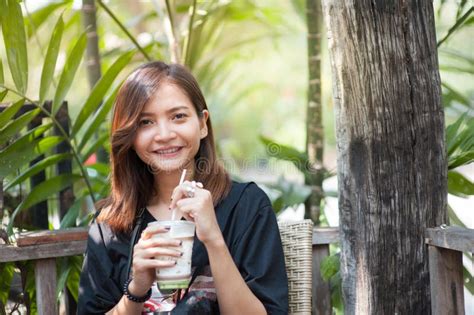 Beautiful Asian Girl Is Sucking Green Tea In A Coffee Shop Happy To Relax Stock Image Image