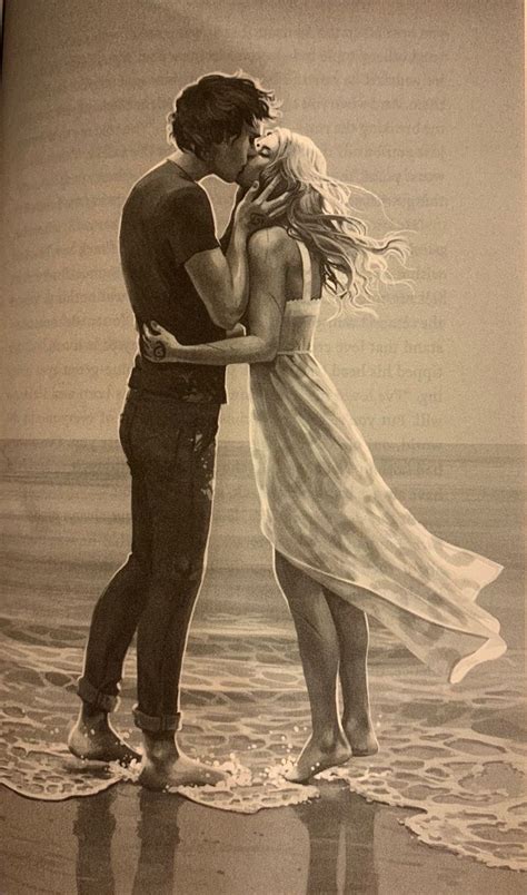 A Man And Woman Kissing On The Beach In Front Of An Open Book With Text