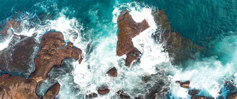 Download Wallpaper 2560x1080 Rocks Aerial View Sea Coast Dual Wide