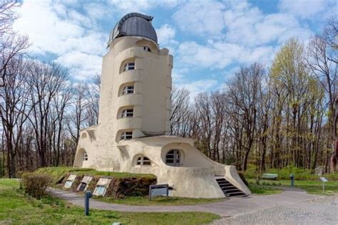 An Unusual Looking Building In The Middle Of A Park With Stairs Leading